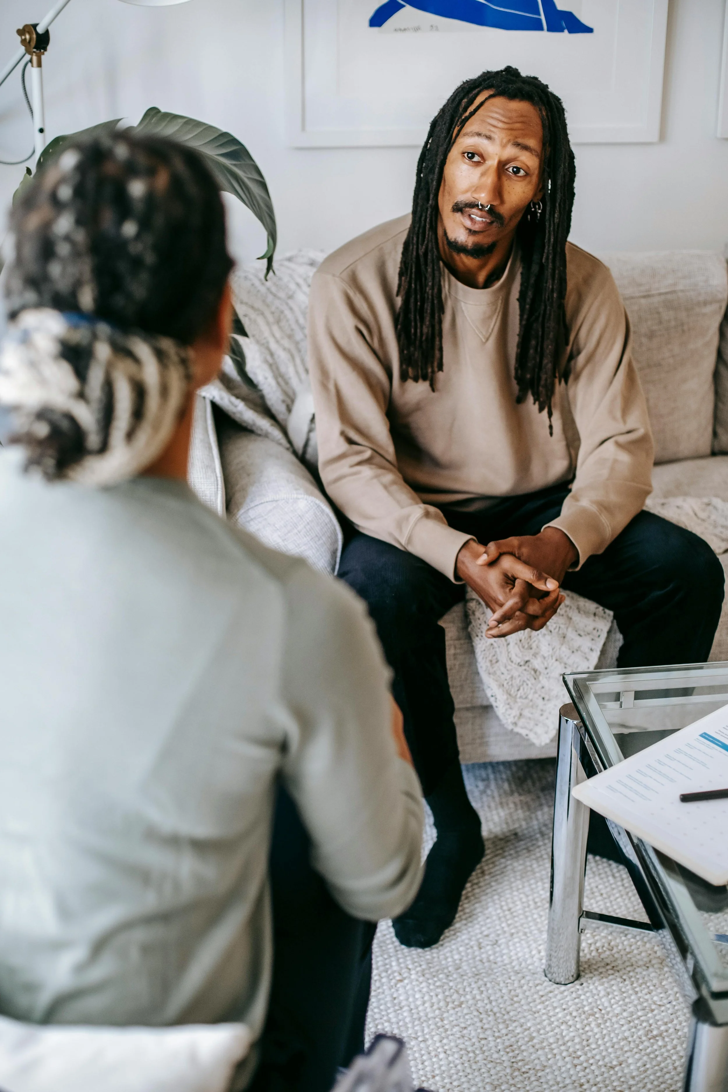 Therapy session mood: two people talking on a couch in a sunlit room. Marketing photo from Keeping Hopes Alive’s website.